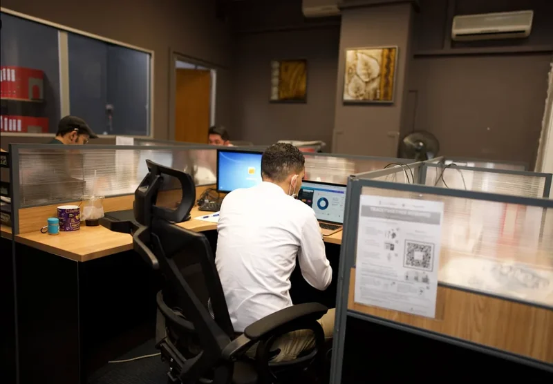 Fastrans operations staff coordinating shipments at their workstations in the Singapore office